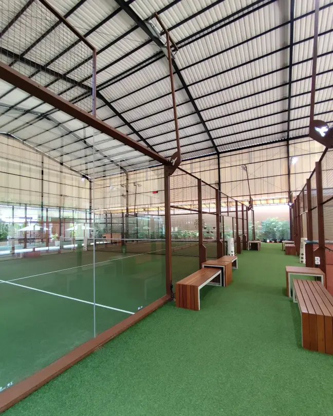 Benches along the glass beside the courts
