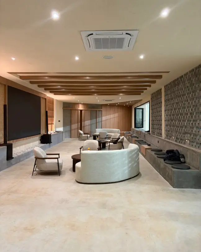 Lounge with curved sofa and timber ceiling