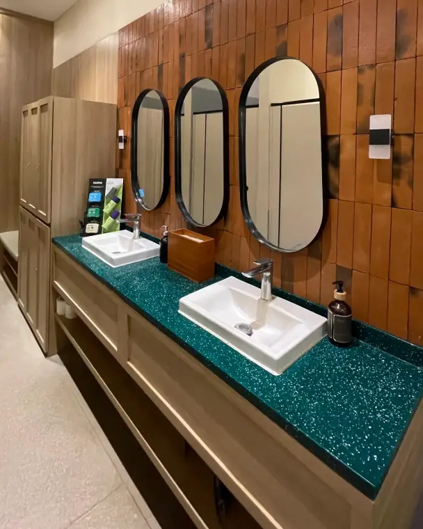 Vanity with oval mirrors and timber tiles